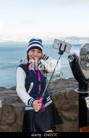 Asian woman, selfie stick, taking selfie, selfie photo, Vista Point, north side of Golden Gate Bridge, city of Sausalito, Sausalito, California Stock Photo