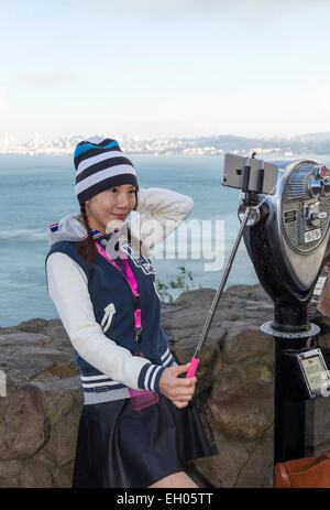 Asian woman, selfie stick, taking selfie, selfie photo, Vista Point, north side of Golden Gate Bridge, city of Sausalito, Sausalito, California Stock Photo