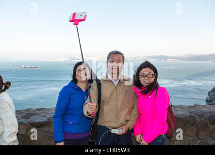 tourists, family, taking selfie, selfie photo, selfie stick, Vista Point, north side of Golden Gate Bridge, city of Sausalito, Sausalito, California