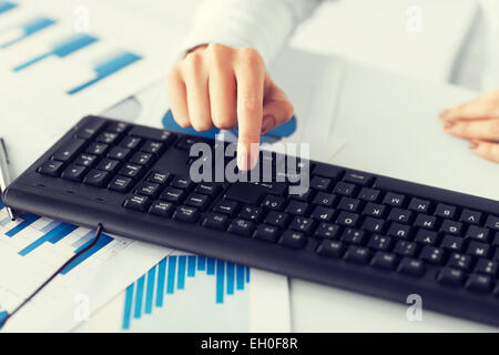 woman hand pressing enter button on keyboard Stock Photo