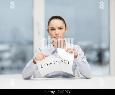 serious businesswoman tearing contract Stock Photo