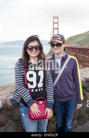 Asian women, posing for photograph, tourists, visitors, visiting, north side of Golden Gate Bridge, Vista Point, city of Sausalito, California Stock Photo