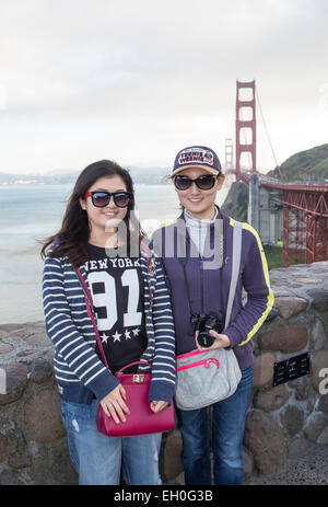 Asian women, posing for photograph, tourists, visitors, visiting, north side of Golden Gate Bridge, Vista Point, city of Sausalito, California Stock Photo