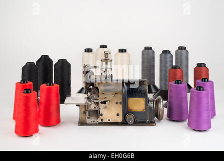Well used Industrial Sewing Machine with an assortment of colorful Spools of Thread. Stock Photo