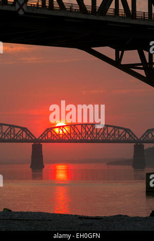 Sunset over the old WW2 railway bridge over the Irrawaddy river ( Ava bridge ) at Mandalay, Myanmar ( burma ), Asia Stock Photo