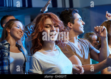 happy friends dancing at night club Stock Photo