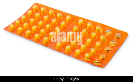 Yellow pills in a blister pack isolated on white background Stock Photo