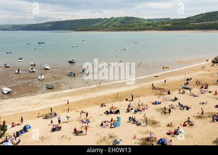 Holidaymakers on the beach near the harbour, New Quay, Ceredigion, Wales. Stock Photo