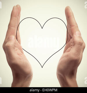 man hands holding a silhouette of a heart, with a retro effect Stock Photo