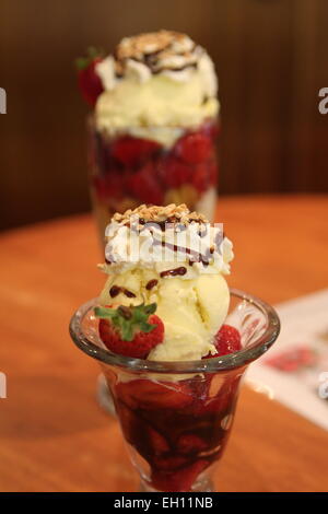 Vanilla ice cream with fresh strawberries and crush peanuts Stock Photo