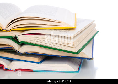 A stack of open, colorful book with a white background Stock Photo