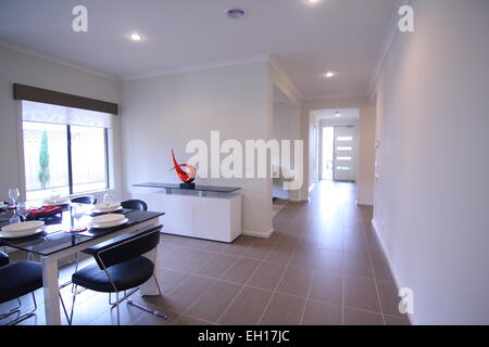 Dining room of a modern home showing the hall way on the side Stock Photo