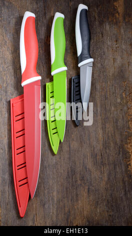 ceramic knifes on old wooden table Stock Photo