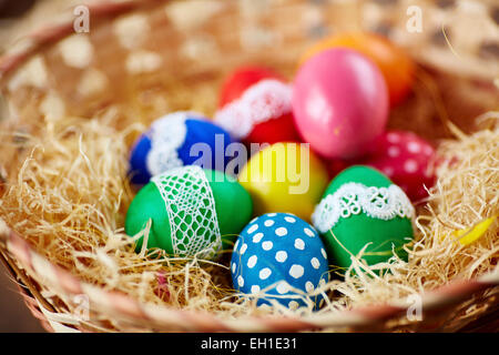 Multicolored Easter eggs in a basket Stock Photo