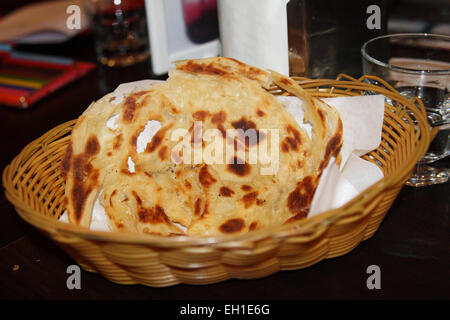 Freshly made roti canai served in a plastic basket Stock Photo