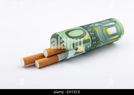 Smoking is expensive. 3 cigarettes wrapped up with a 100 Euro (EUR) note. Stock Photo