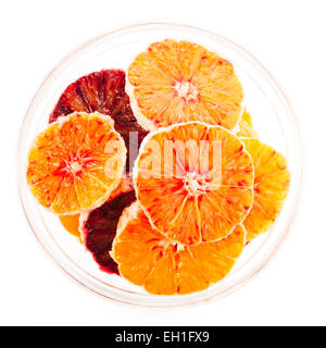 Orange and blood orange slices in glass bowl isolated on white Stock Photo