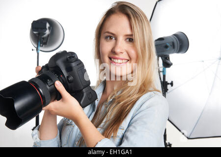 Female Professional Photographer Working In Studio Stock Photo