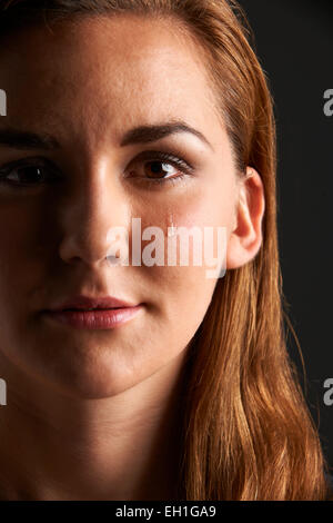 Studio Portrait Of Young Woman Crying Stock Photo