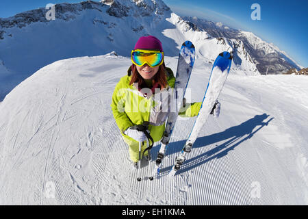 View of woman in mask standing and holding ski Stock Photo