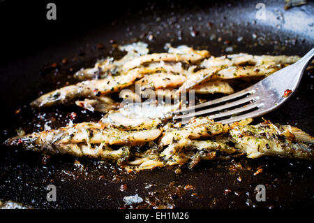 Sprat, capelin fried in a frying pan top view Stock Photo