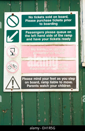 Instruction signs on station pier at Hythe, Hampshire, UK Stock Photo