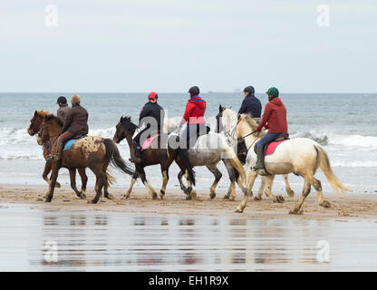 Saltburn by the sea, UK. 5th March, 2015. UK Weather: Horseriders on Saltburn beach on an overcast but noticibly milder Thursday morning in the north east of England. Credit:  ALANDAWSONPHOTOGRAPHY/Alamy Live News Stock Photo