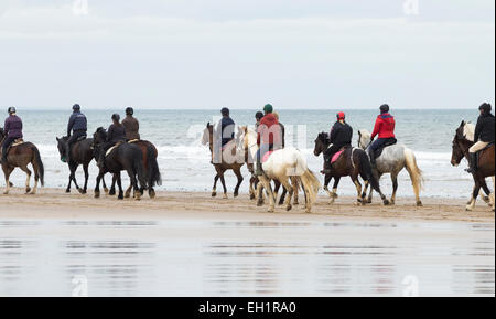 Saltburn by the sea, UK. 5th March, 2015. UK Weather: Horseriders on Saltburn beach on an overcast but noticibly milder Thursday morning in the north east of England. Credit:  ALANDAWSONPHOTOGRAPHY/Alamy Live News Stock Photo