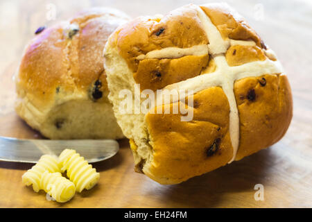 Hot cross bun made from a rich yeast dough of flour, milk, sugar, butter, eggs, currants, and spices, such as cinnamon, nutmeg, Stock Photo