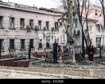 Donetsk, Ukraine. 4th March, 2015. A woman walks past destroyed Stock