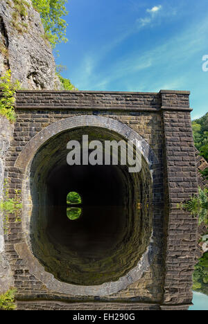 Railway tunnel entrance on the Monsal trail,Derbyshire peak district England UK.digitally mirrored image Stock Photo