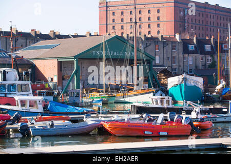 General view of Underfall Yard in Bristol seen across the water with boats in the foreground. Stock Photo