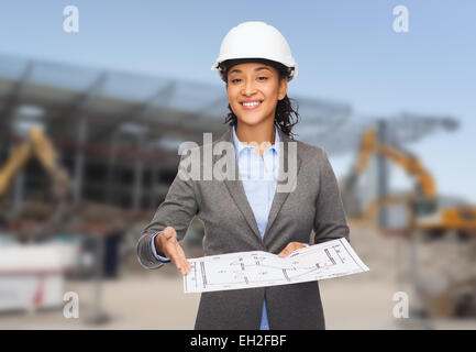 businesswoman in white helmet with blueprint Stock Photo