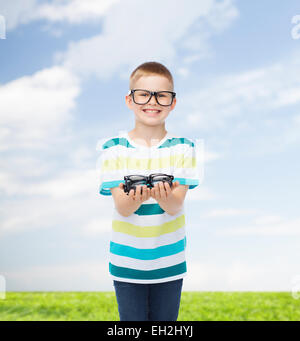 smiling boy in eyeglasses holding spectacles Stock Photo