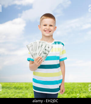 smiling boy holding dollar cash money in his hand Stock Photo