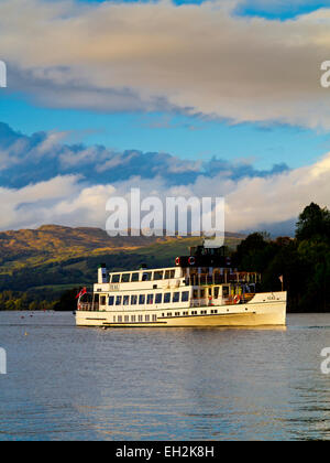 Passenger boat MV Teal sailing across Lake Windermere in the Lake District National Park with view of mountains in background UK Stock Photo