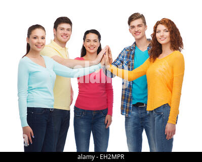 smiling teenagers making high five Stock Photo