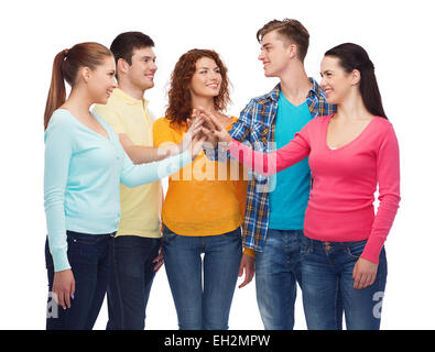 smiling teenagers making high five Stock Photo