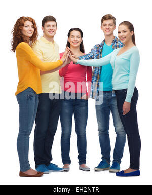 group of smiling teenagers making high five Stock Photo