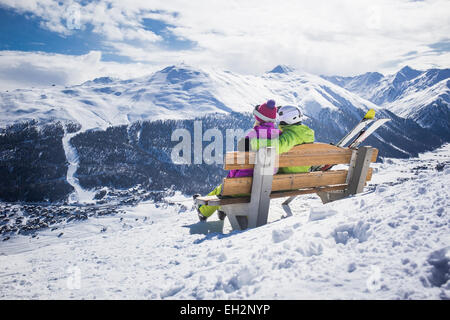 Young couple hugging ski resort winter mountains Stock Photo