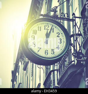 Old clock at railway station. Retro style filtred image Stock Photo