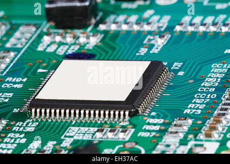 Macro close up of a cpu core microprocessor on a computer electronic circuit motherboard with selective focus on white space Stock Photo