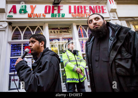 FILE IMAGES: London, UK. 13th December 2013. Islamist Abu Rumaysah - real name Siddhartha Dhar, currently in Syria after fleeing Britain on police bail was a close associate of Anjem Choudary and his London-based militant Islam group. Pictured here (Left) Dec 13th 2013 in Brick Lane, London during an Islamist protest. Rumaysah was arrested along with Anjem Choudary in September 2014 and accused of encouraging terrorism and promoting the banned group al-Muhajiroun. Credit:  Guy Corbishley/Alamy Live News Stock Photo