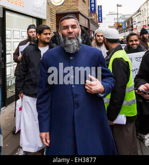 FILE IMAGES: London, UK. 13th December 2013. Islamist Abu Rumaysah - real name Siddhartha Dhar, currently in Syria after fleeing Britain on police bail was a close associate of Anjem Choudary and his London-based militant Islam group. Pictured here (2nd Left) Dec 13th 2013 with Anjem Choudary (C) in Brick Lane London during an anti-alcohol Islamist protest. Rumaysah was arrested along with Anjem Choudary in September 2014 and accused of encouraging terrorism and promoting the banned group al-Muhajiroun. Credit:  Guy Corbishley/Alamy Live News Stock Photo