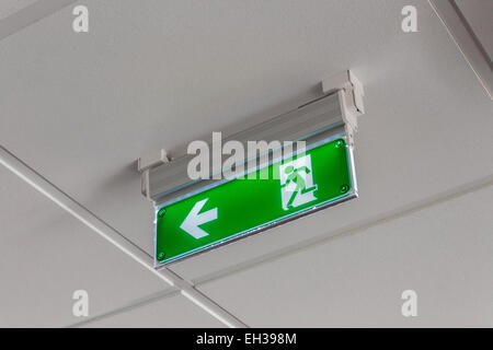 green exit sign pointing down Stock Photo