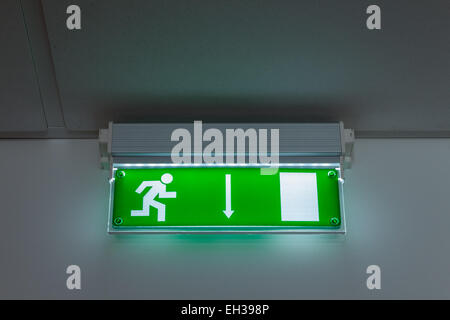 green exit sign pointing down Stock Photo