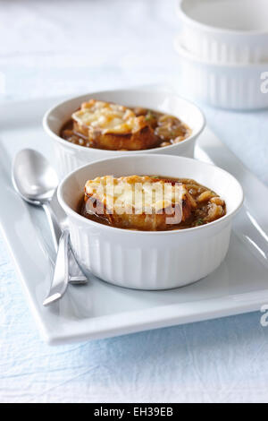 Close-up of Bowls of French Onion Soup with Chickpeas, Crusty Bread and Melted Cheese, Studio Shot Stock Photo