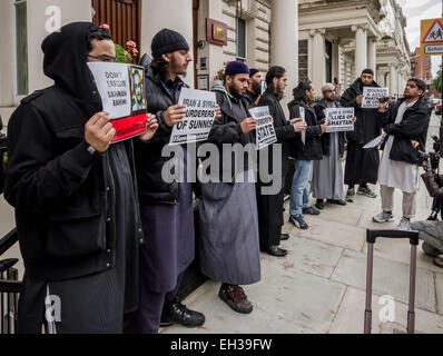 FILE IMAGES: London, UK. 18th Sept, 2013. Islamist Abu Rumaysah - real name Siddhartha Dhar, currently in Syria after fleeing Britain on police bail was a close associate of Anjem Choudary and his London-based militant Islam group. Pictured here (far right) September 18th 2013 outside Iranian Embassy in London during an Islamist protest. Rumaysah was arrested along with Anjem Choudary in September 2014 and accused of encouraging terrorism and promoting the banned group al-Muhajiroun. Credit:  Guy Corbishley/Alamy Live News Stock Photo