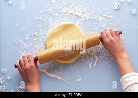 Overhead View of Woman Rolling out Sugar Cookie Dough, Studio Shot
