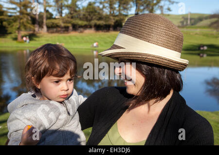 Mother and child at a picnic by the pond, Petaluma, California, USA Stock Photo